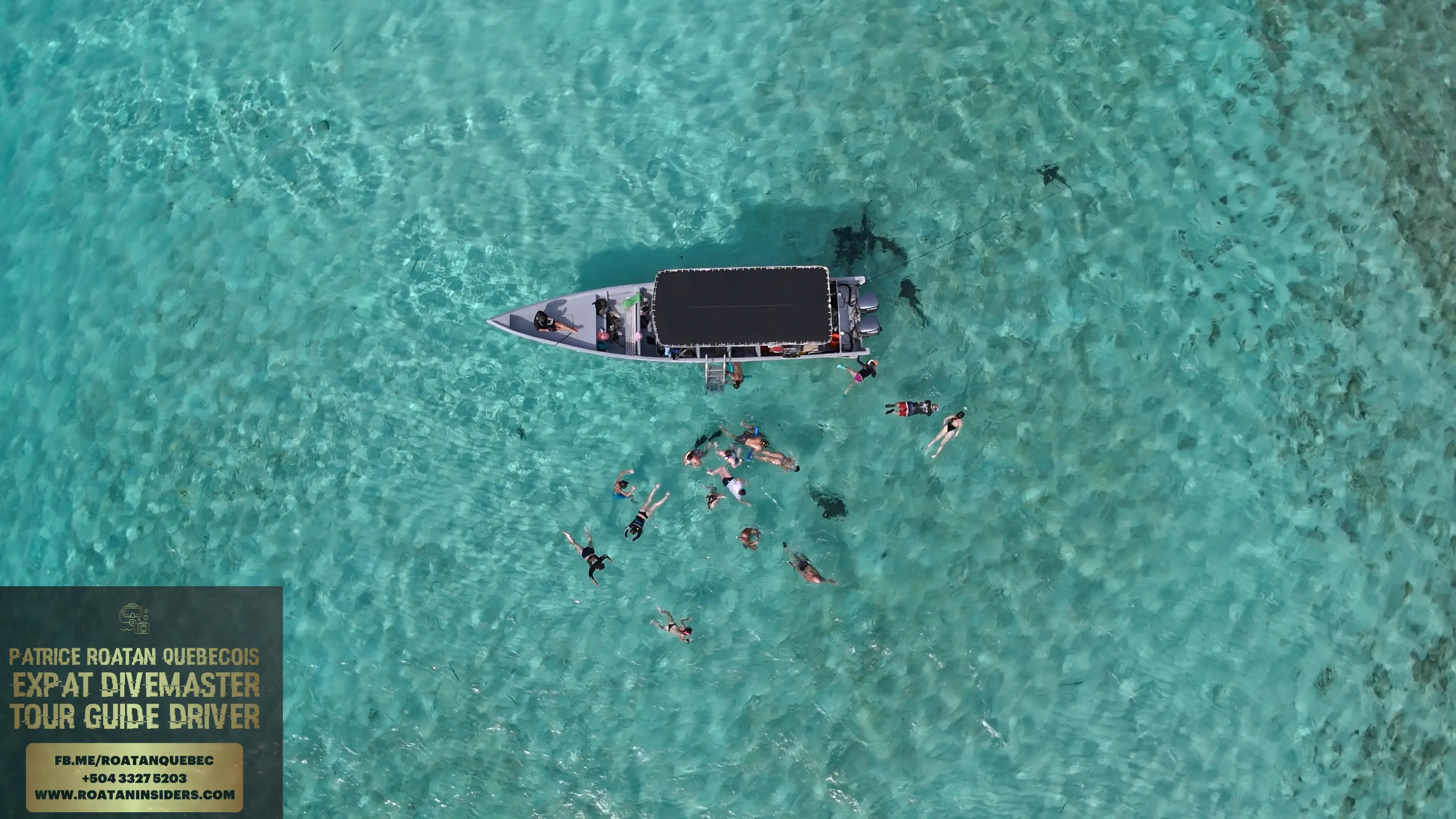 The Pigeon Cay tour boat and swimmers in turquoise water
