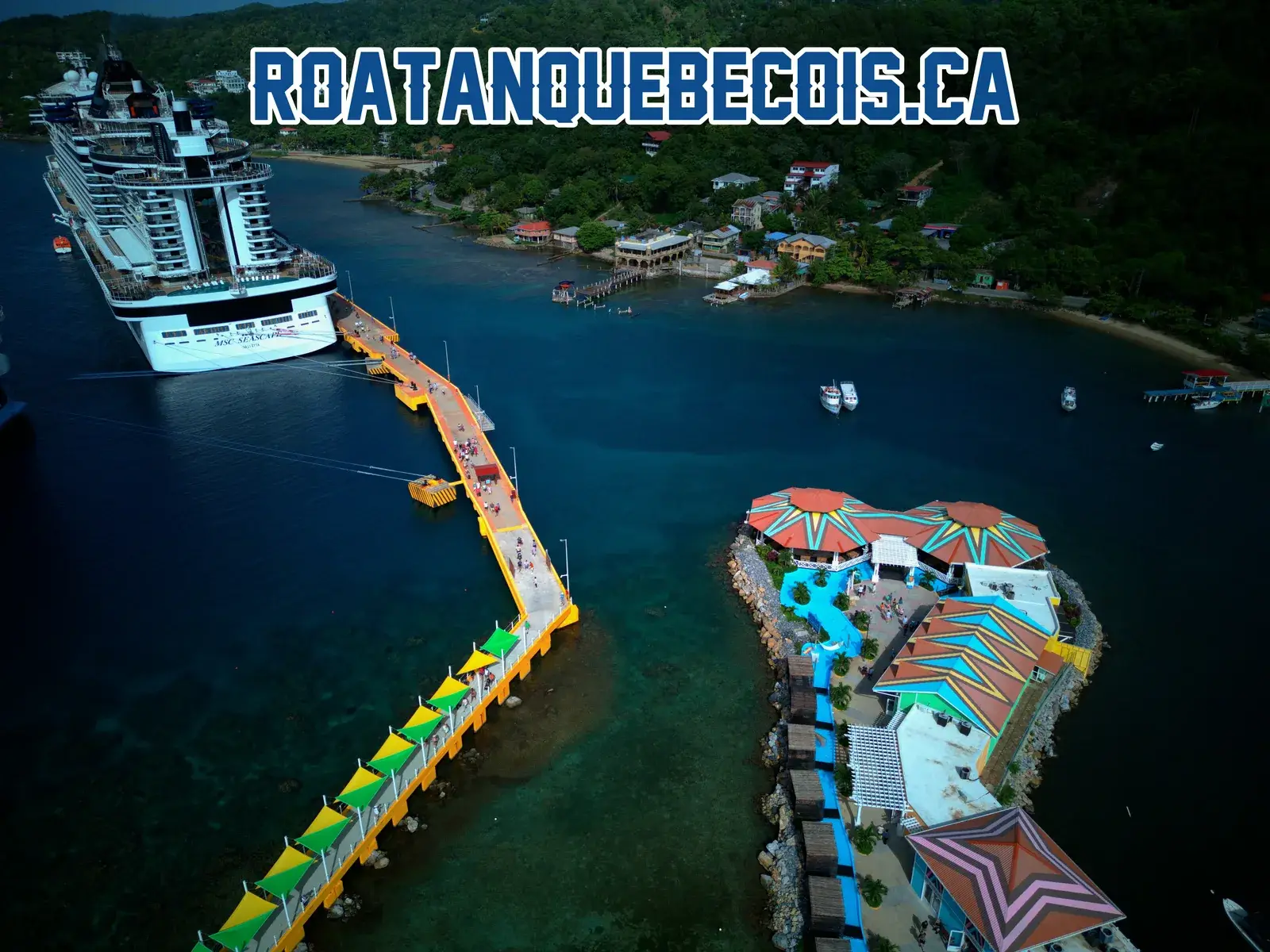 The west pier at Port of Roatán, its green and yellow canopied walkway curving in to the terminal, a ship moored at the far end