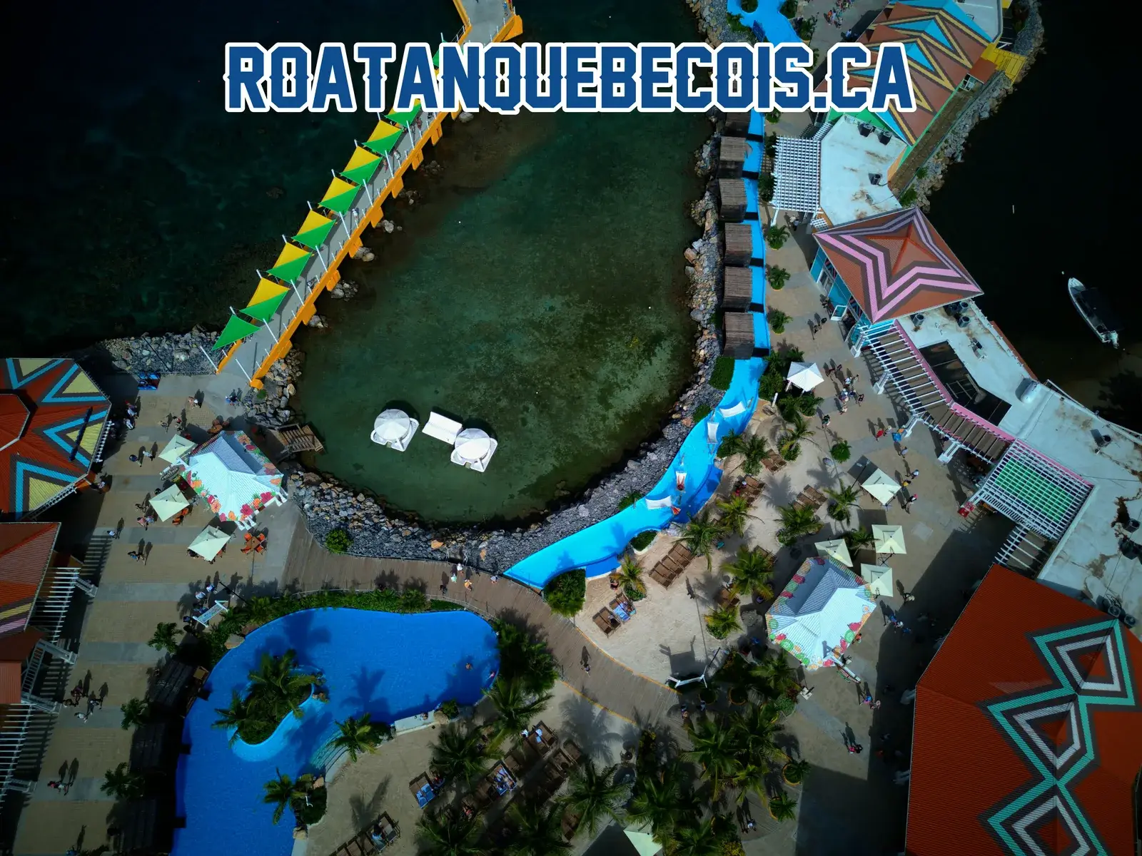 The canopied walkway reaching the Port of Roatán terminal, the tidal lagoon and the two swimming pools
