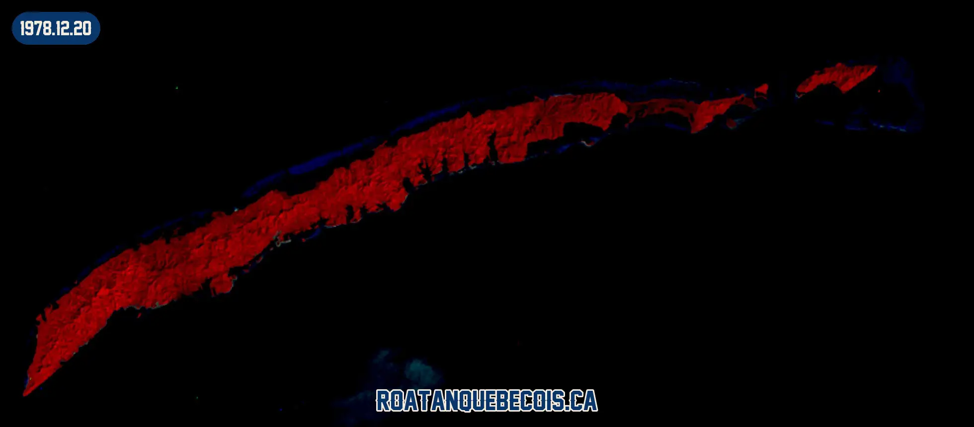 Roatán vue du ciel le 20 décembre 1978, en fausse couleur infrarouge où la végétation apparaît en rouge : l'île entière, son récif et les zones bâties