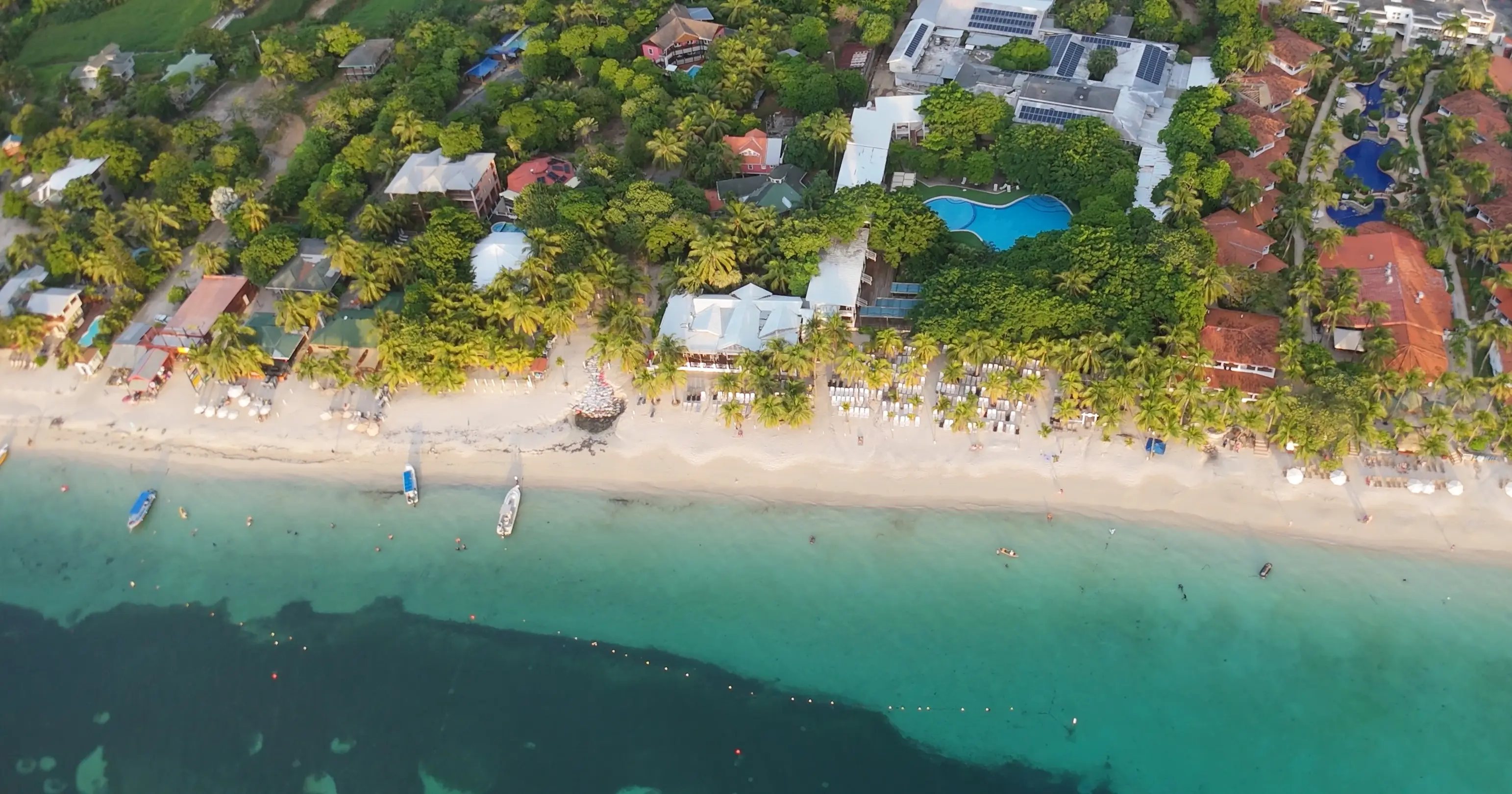 West Bay Beach by drone, white sand and beachfront resorts